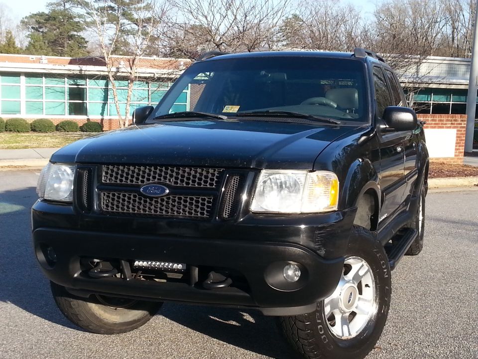 Black 2001 Ford Explorer Sport Trac front view with custom grille and LED light bar.