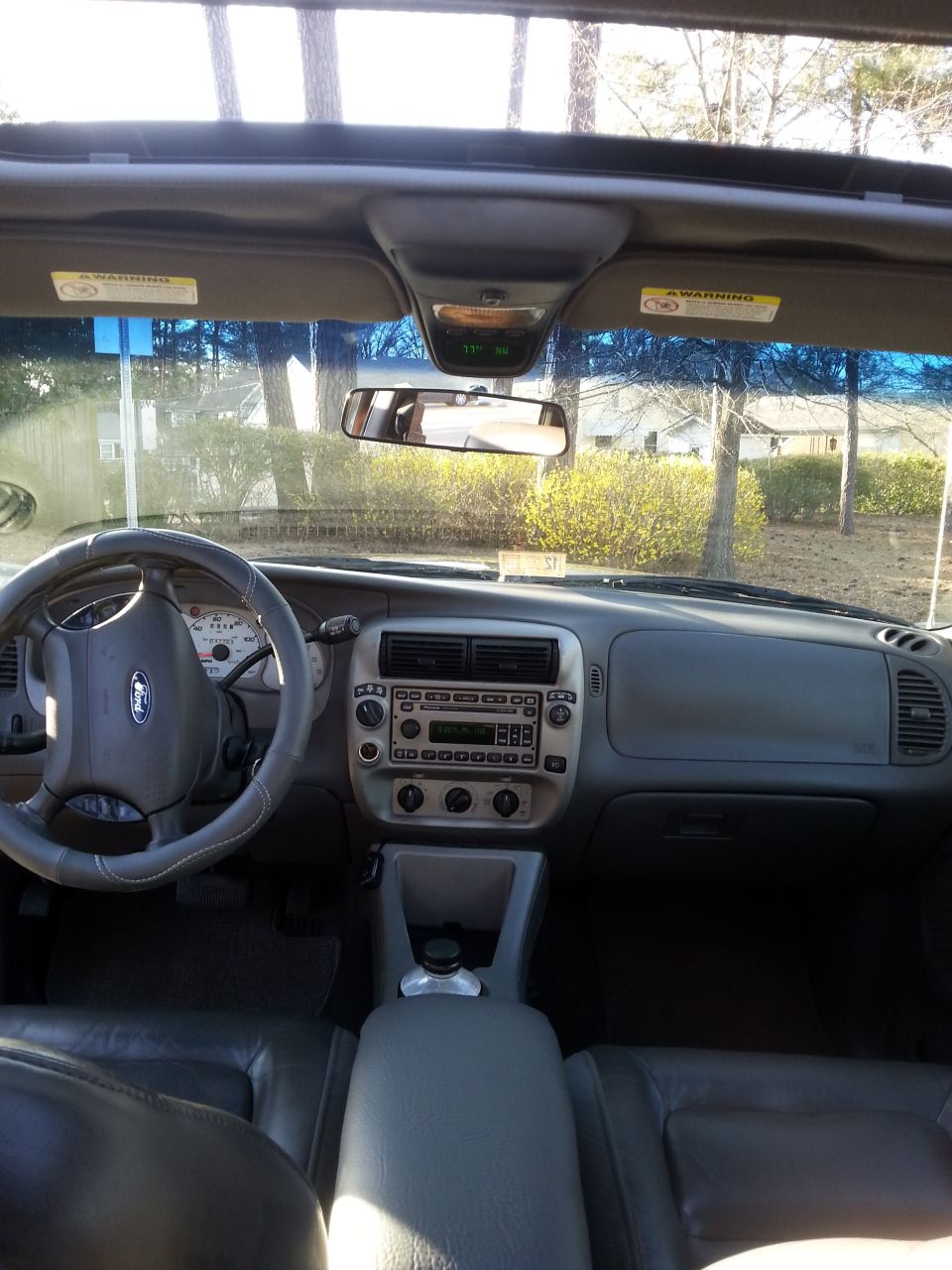 Interior of a 2001 Ford Explorer Sport Trac, showing dashboard, steering wheel, and seats.