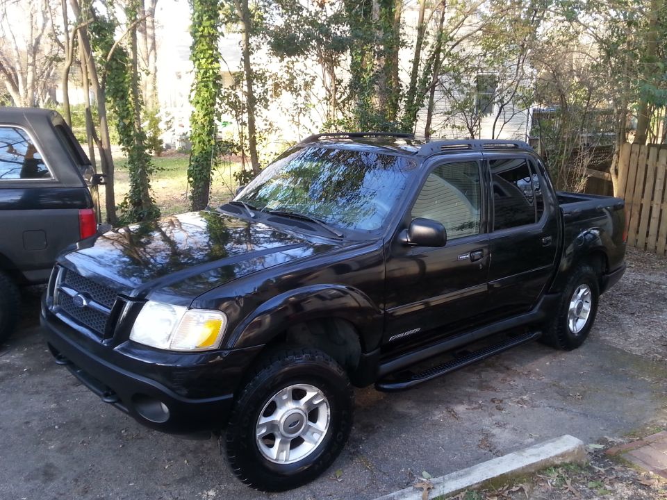 Black 2001 Ford Explorer Sport Trac parked outdoors.