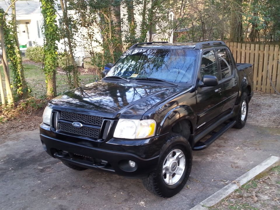 Black 2001 Ford Explorer Sport Trac parked outdoors.