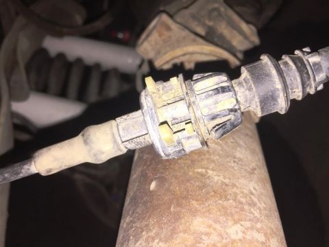 1996 Ford Bronco - Close-up of a spark plug, likely removed from an engine for inspection or replacement.