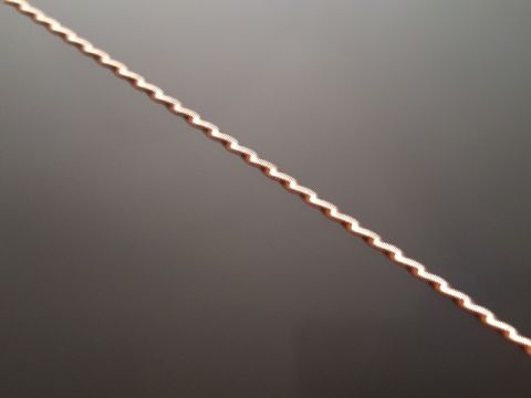 2007 Dodge Durango - A close-up of a decorative metal trim piece with a wavy pattern, a website logo.