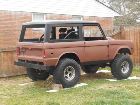 1972 Ford Bronco - This 1970s Ford Bronco is in a state of restoration, with its body showing primer and some rust.