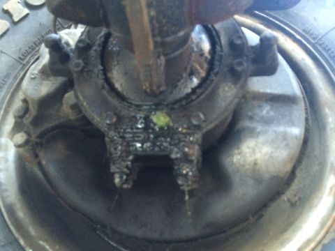 1987 Suzuki Samurai - Detail of a vehicle's wheel hub and brake assembly, showing signs of grease and potential leaks.