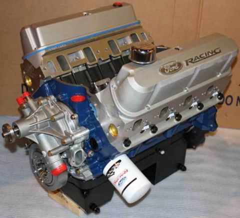 1982 Ford Bronco - A close-up, angled view of a Ford Racing V8 engine, predominantly silver and blue, with a white oil filter attached. The engine is mounted…