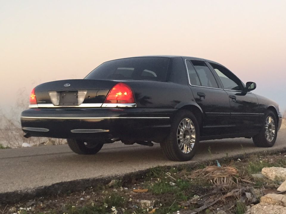 Black sedan, rear passenger side view