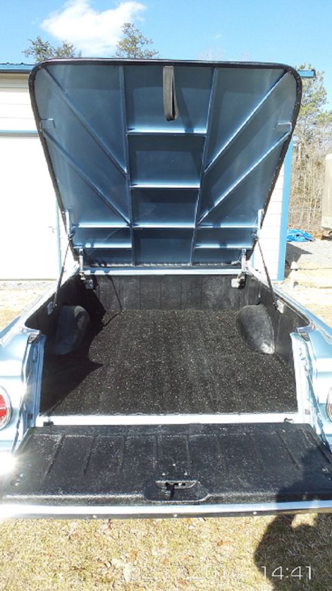 1965 Ford Ranchero - The rear of a vehicle, likely a truck bed, is shown with a clear sky in the background.