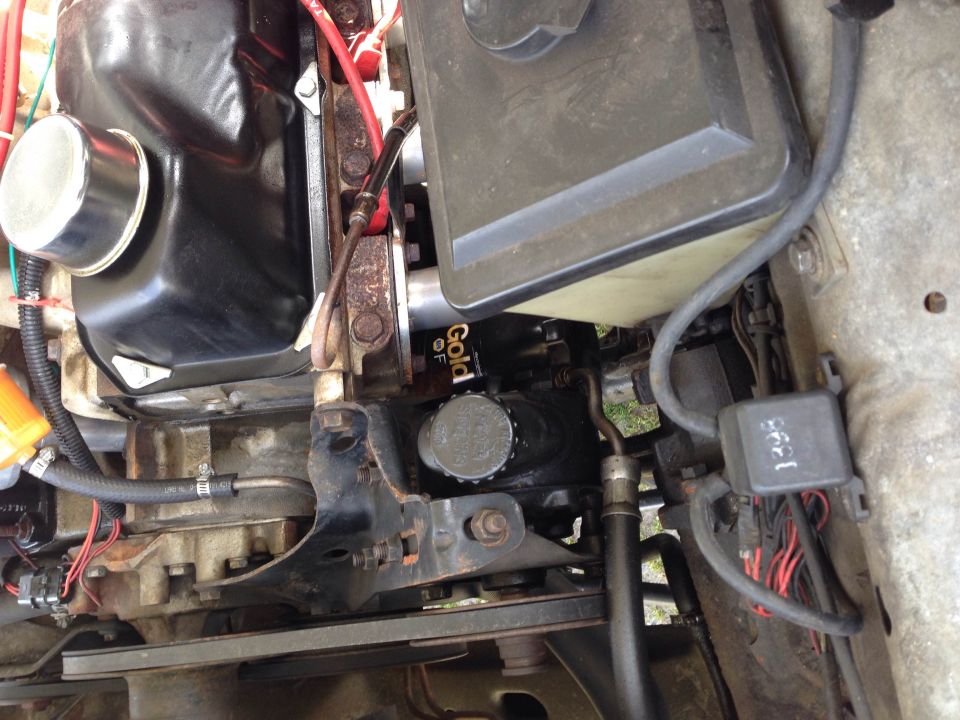 Engine bay detail showing oil filter labeled "Gold OF"