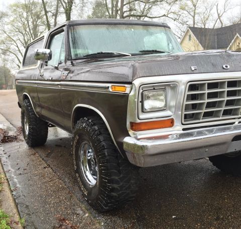 1978 Ford Bronco - This 1978 Ford Bronco features a prominent chrome grille and aggressive off-road tires, captured from a three-quarter front view.