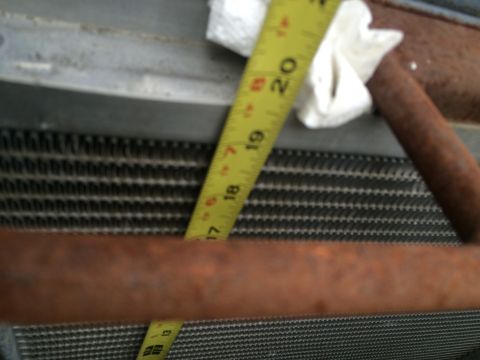 1987 Suzuki Samurai - Measuring a radiator with a tape measure. The measurement is around 17.5 inches.
