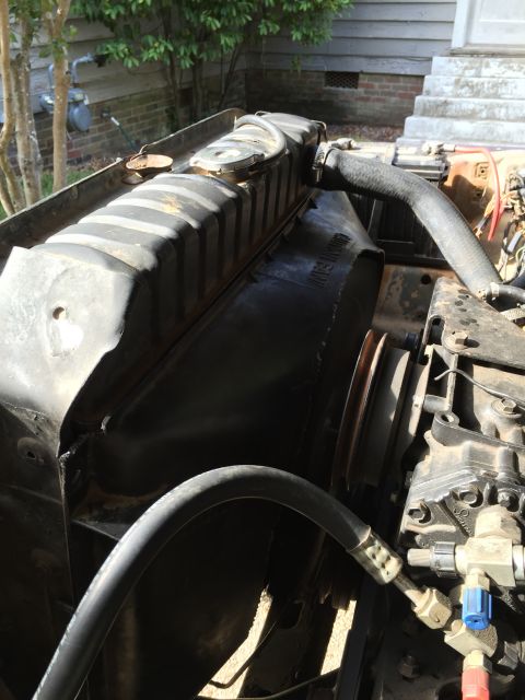 1978 Ford Bronco - Close-up view of the radiator and engine bay components, showing hoses and a fan shroud.