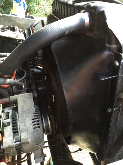 1978 Ford Bronco - Close-up view of engine bay components including an alternator and fan shroud.