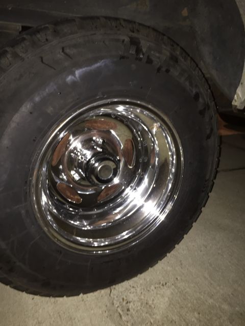 1978 Ford Bronco - Close-up of a chrome wheel and tire, showing details of the rim and tread.