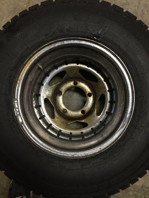 1978 Ford Bronco - A tire and wheel assembly is shown, with the wheel a star-like pattern of holes.
