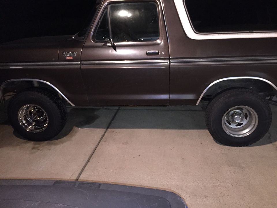 Side view of a brown 1978 Ford Bronco with a white top