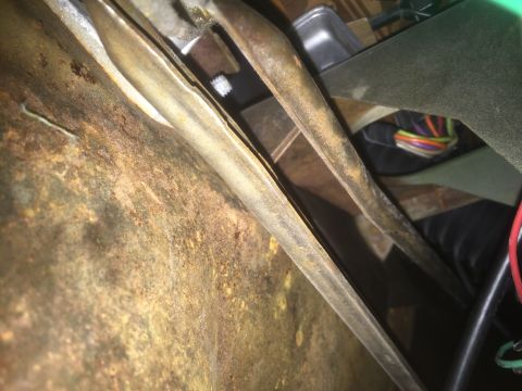1971 Dodge Dart - The underside of a vehicle shows significant rust and exposed wiring, indicating potential maintenance needs.