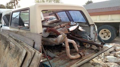 1981 Ford Bronco - The bed of a vintage pickup truck is filled with exhaust system parts and other scrap metal. A large truck with a yellow bed and a white ca…