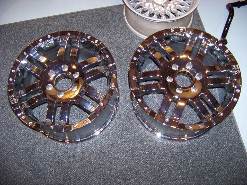 Two chrome Moto Metal wheels with a multi-spoke design.
