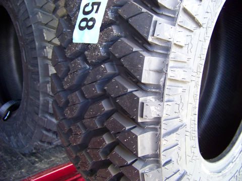2005 Ford F-150 - A close-up view of two off-road tires, one with a tag showing the number "58". The tires are mounted and appear to be in a vehicle bed or o…