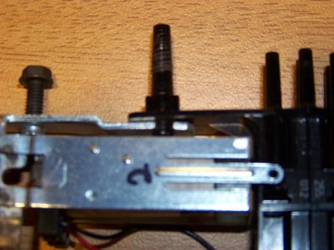 1999 Mercury Grand Marquis - A close-up view shows a metal bracket with a bolt and a black plastic component with several black posts. A handwritten number "2" is visib…