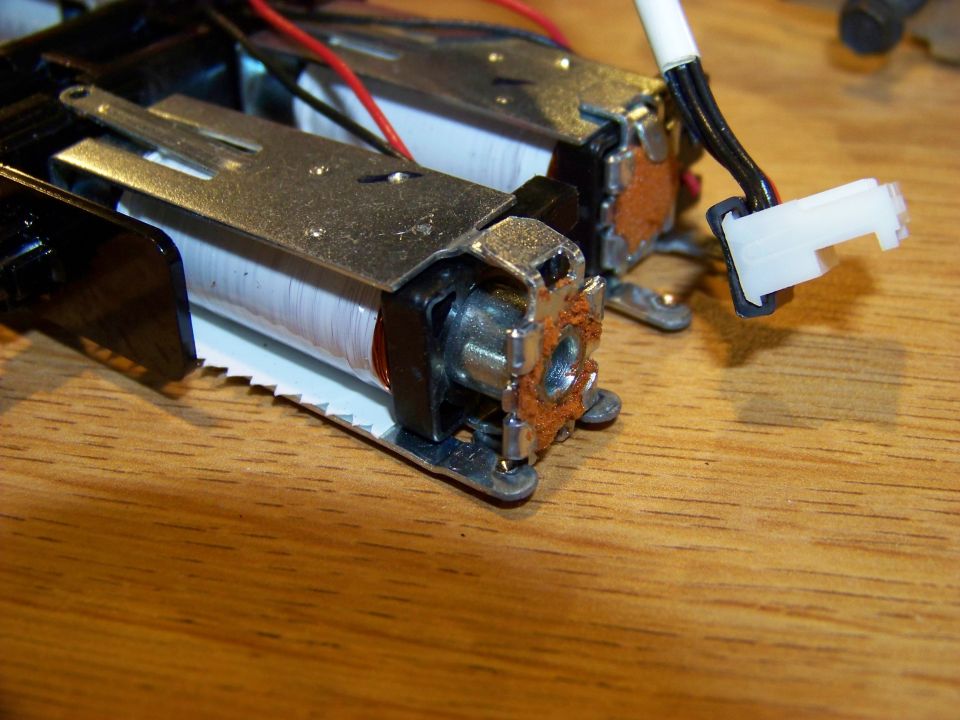 Close-up of electromagnetic coils with copper windings and a white electrical connector.