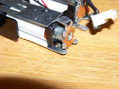 1999 Mercury Grand Marquis - This image shows a close-up view of electronic components, possibly from a motor or a similar device, resting on a wooden surface. The comp…
