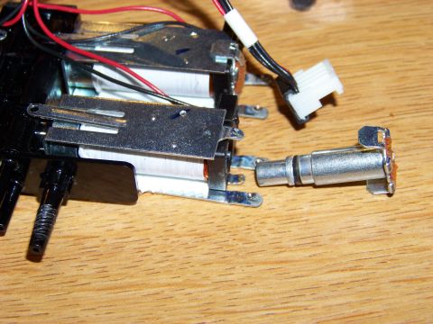 1999 Mercury Grand Marquis - This is a close-up shot of electronic components, possibly from a device or appliance, resting on a wooden surface. The components include…