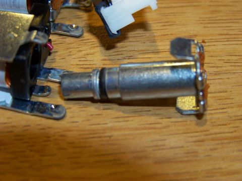 1999 Mercury Grand Marquis - A close-up shows a metal audio jack connector with black rings, attached to a circuit board with copper coils. The connector and board are…