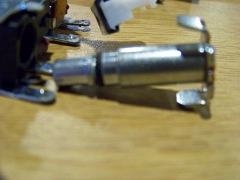 1999 Mercury Grand Marquis - Close-up view of electronic components, possibly from a vehicle's dashboard or control panel, resting on a wooden surface.