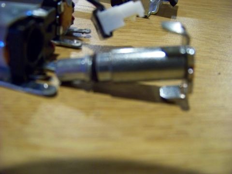 1999 Mercury Grand Marquis - A close-up, shallow depth of field shot shows a metal component with a white plastic connector attached. The component appears to be part o…
