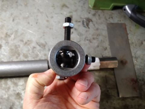 1992 Ford Bronco - A hand holds a steering shaft joint assembly, showing the ball bearings within the housing.