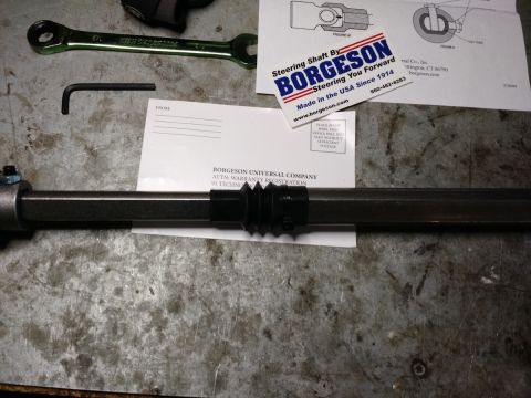 1992 Ford Bronco - Borgeson steering shaft, diagram, and warranty card laid out on a workbench.