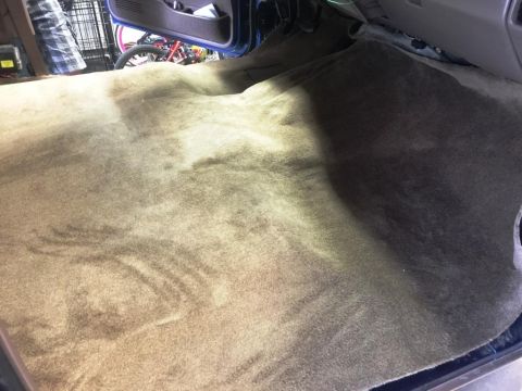 1996 Ford Bronco - The worn carpet covers the floor of a vehicle's interior.
