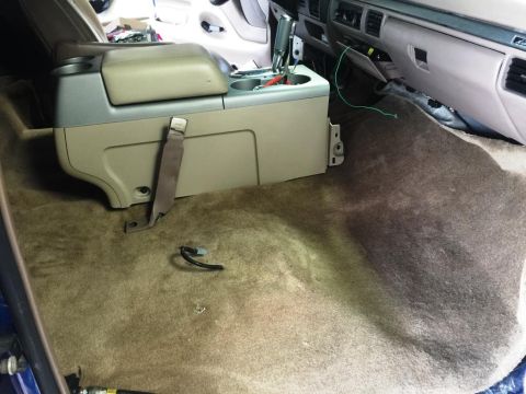 1996 Ford Bronco - Interior view of a vehicle showing the exposed floor and center console removed.