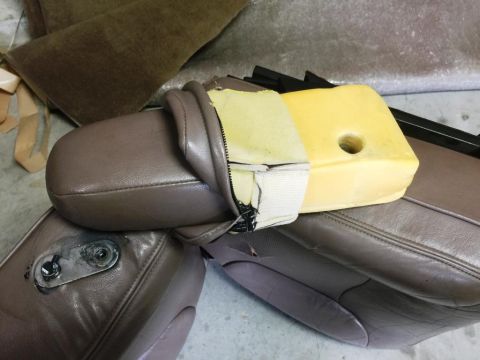 1996 Ford Bronco - A disassembled car seat cushion shows the internal foam and damaged fabric cover.