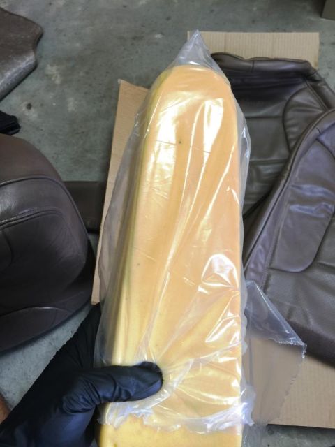 1996 Ford Bronco - New seat foam padding is being held, with seat covers in the background.