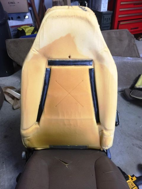 1996 Ford Bronco - The foam padding of a car seat is visible, with some staining and a torn fabric base. A website watermark is present.