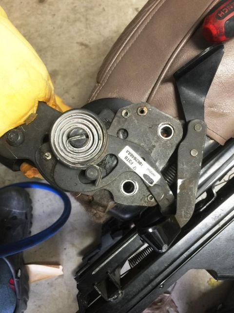 1996 Ford Bronco - Close-up of a seat reclining mechanism, showing a part number label.