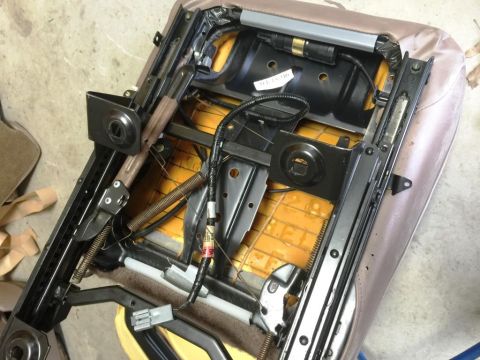 1996 Ford Bronco - Close-up of a car seat's internal frame, showing springs and electrical components.