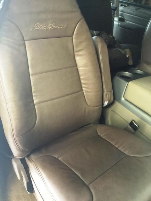 1996 Ford Bronco - Interior shot of a tan leather seat with embroidered Eddie Bauer logo.