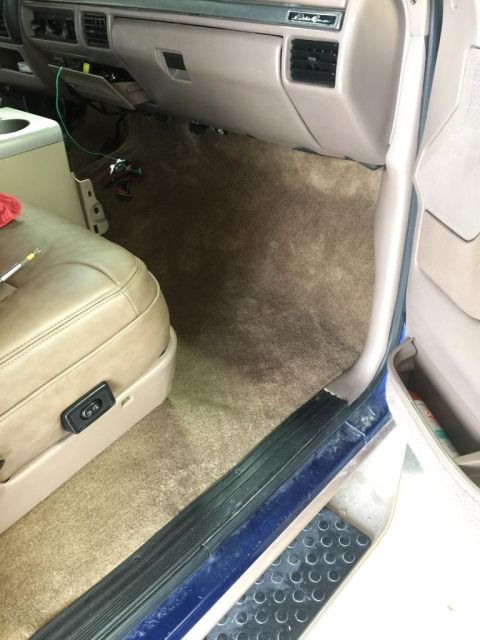 1996 Ford Bronco - Interior of a 1996 Ford Bronco, focusing on the carpet and dashboard area.