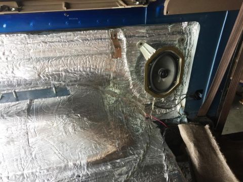 1996 Ford Bronco - The interior of a vehicle shows soundproofing material and a speaker, with no visible year identification.