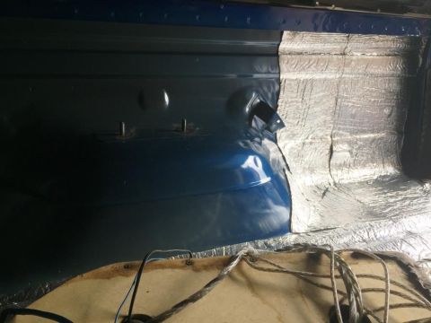1996 Ford Bronco - Sound deadening material is applied to the interior panel of a vehicle.