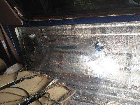 1996 Ford Bronco - Sound deadening material covers the interior panel, with a speaker visible.