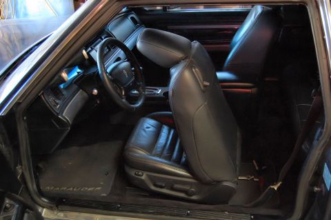 1985 Mercury Grand Marquis - The interior of a car is shown, black leather seats and a dashboard.