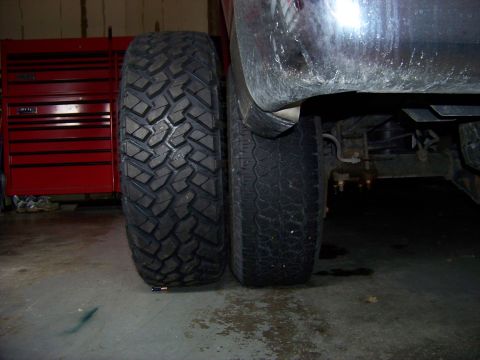 2005 Ford F-150 - A large off-road tire is shown next to a regular vehicle tire, possibly for comparison.