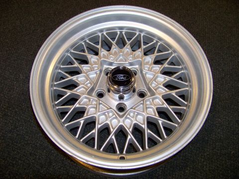 1999 Mercury Grand Marquis - This is a close-up of a silver mesh-style wheel with a black Ford center cap.