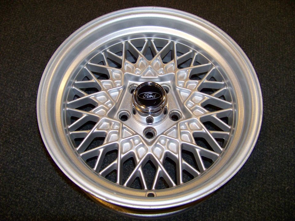 Close-up of a silver mesh-style wheel with a black Ford center cap