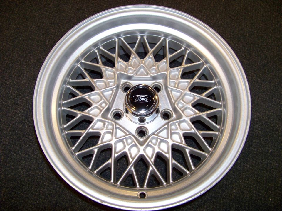 Silver mesh wheel with a Ford logo center cap