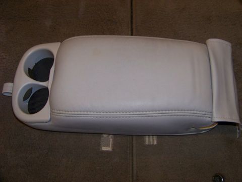 1999 Mercury Grand Marquis - A light gray vinyl center console armrest with two cupholders is shown from an overhead angle.